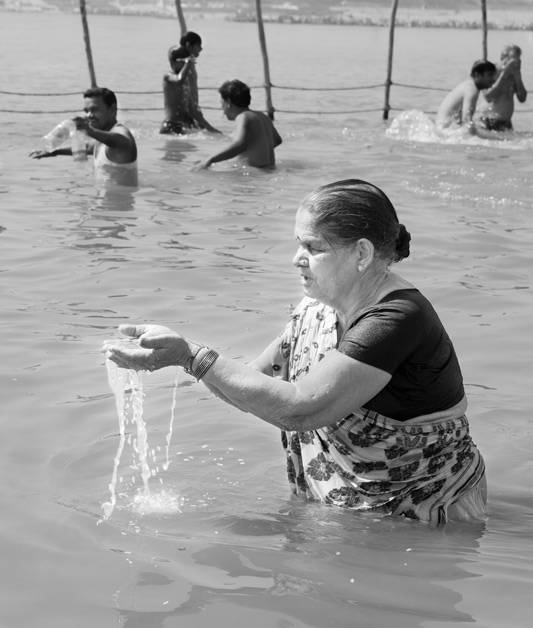 Women and Water Needs from Gender Perspective - Offering water to deities at Sangam - the confluence of rivers Ganges, Yamuna and the mythical Saraswati at Prayag (Allahabad), Uttar Pradesh